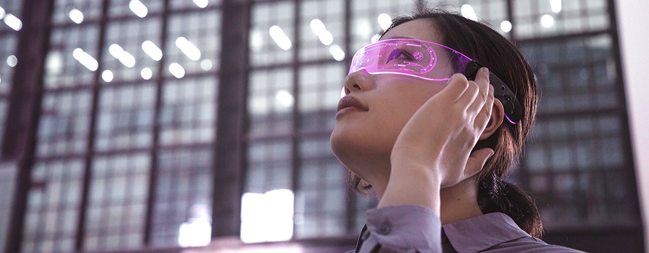 Woman with high-tech glasses gazes upward.