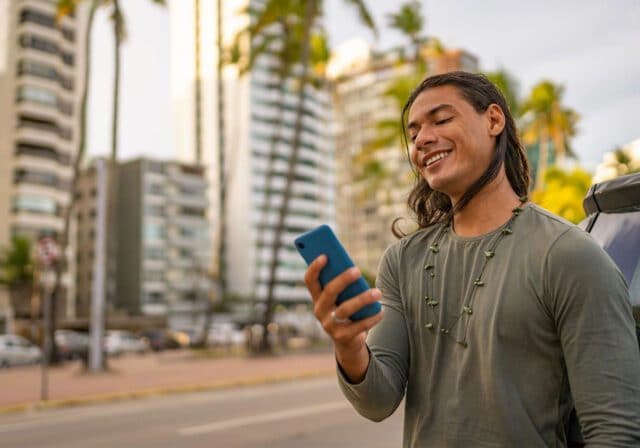 Young Man On Vacation Using Cell Phone