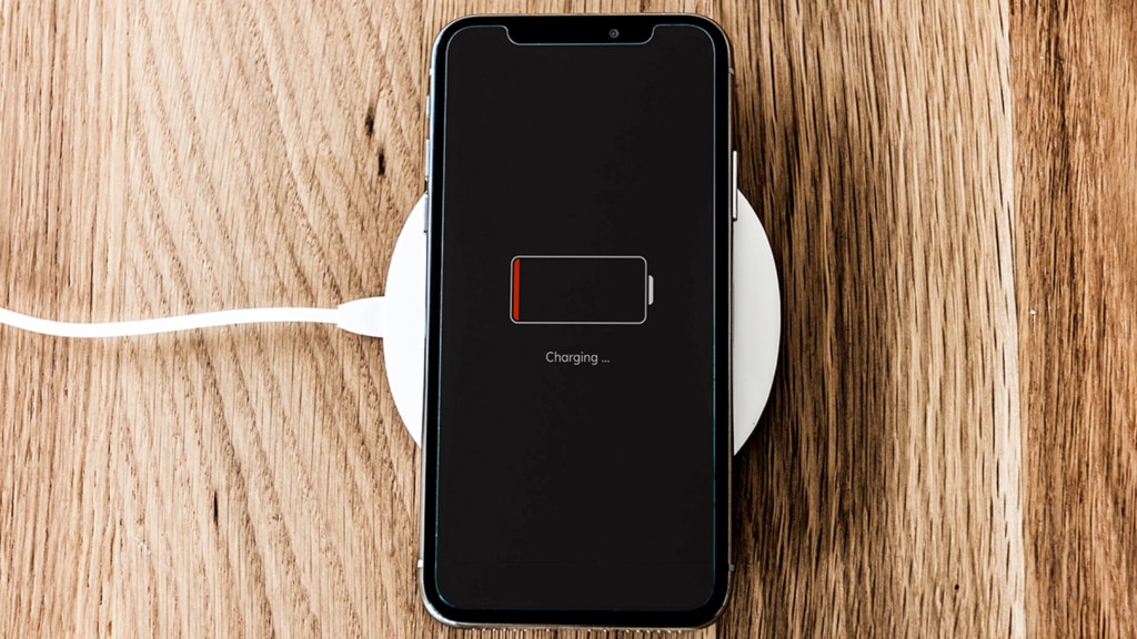 Phone sitting on a wireless charger with a larger charging graphic on the phone