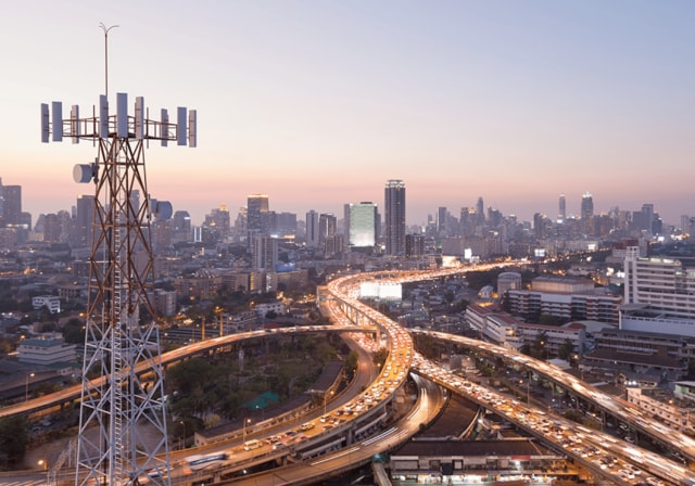 View of a city with a 5G cellphone tower.