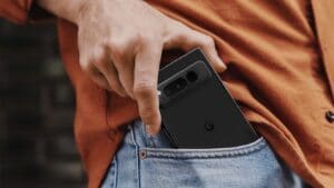 A man pulling a Google Pixel phone out of his pocket.