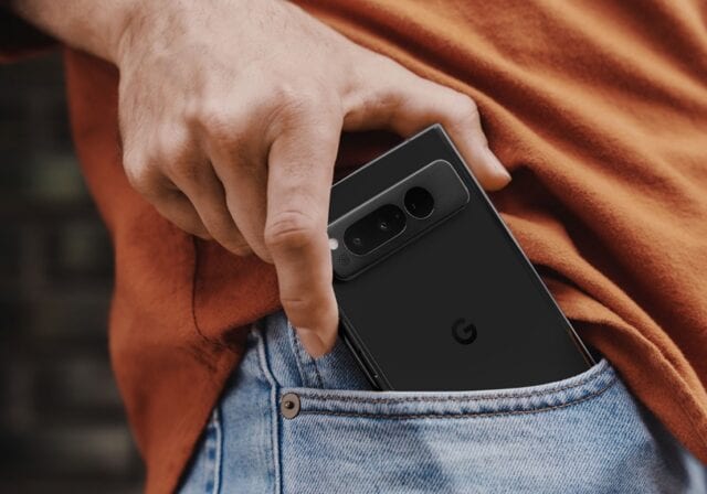 A man pulling a Google Pixel phone out of his pocket.
