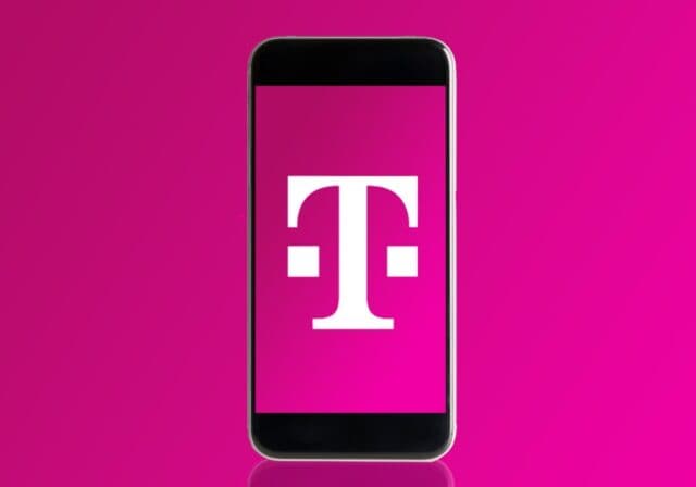 An early model iPhone with the T-Mobile logo displayed on a magenta background.