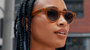 Close up of a person wearing Ray-Ban smart glasses.