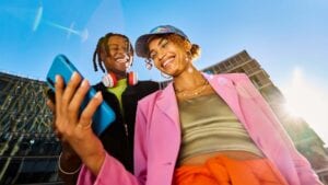 Two friends using a smartphone.