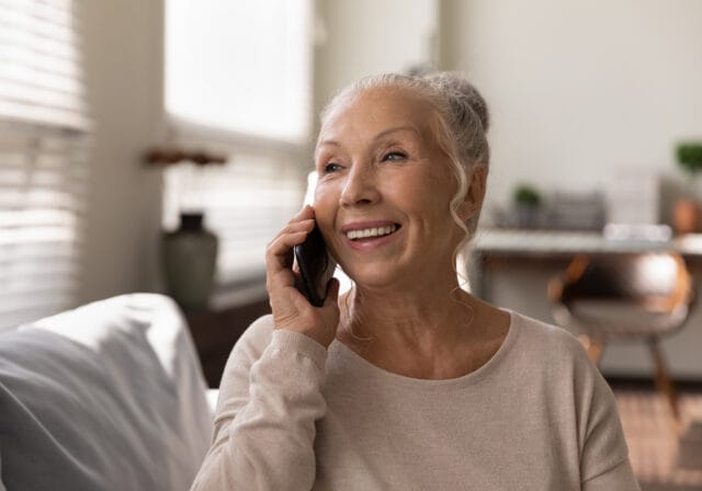 happy-senior-woman-speaking-smartphone