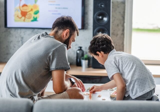 Father-and-son-playing-game-in-living-room