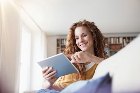 A person using their fast 5G home internet on a tablet.