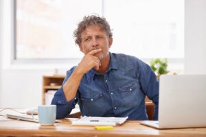 Person thinking about the difference between a router and a modem