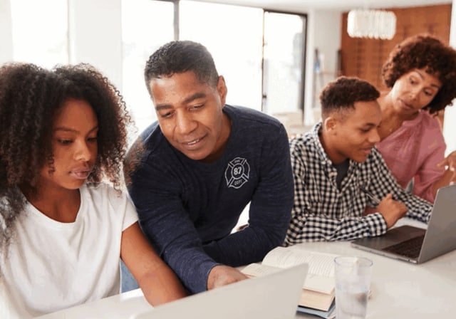 A family using internet connected devices in their kitchen.
