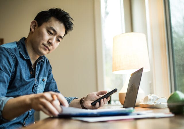 A person sitting in front of an open computer.