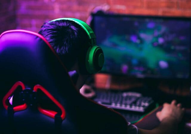 Image of a young gamer playing on a desktop pc.