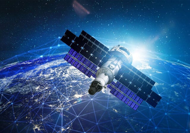 Image of a satellite flying over Earth from space.