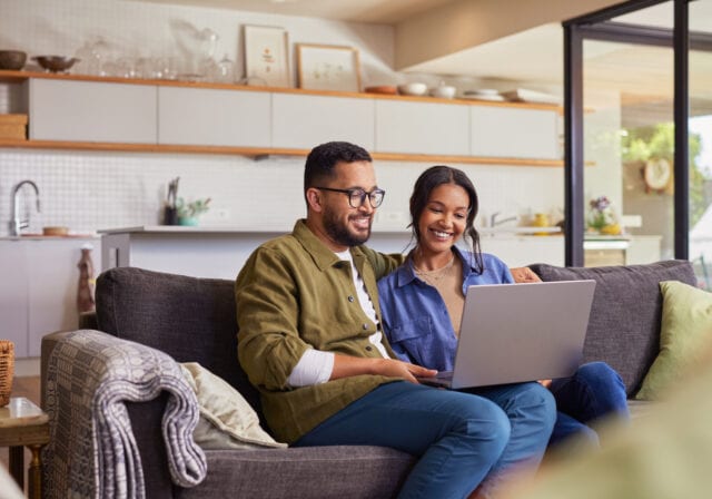 couple-using-laptop-at-home