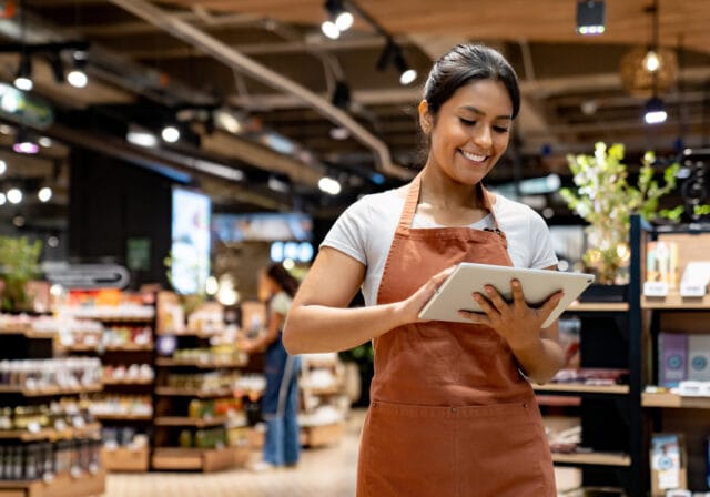 Retail-clerk-using-a-tablet-while-working-at-store