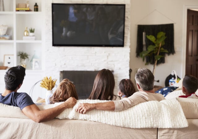 family-sitting-on-couch-while-streaming-tv