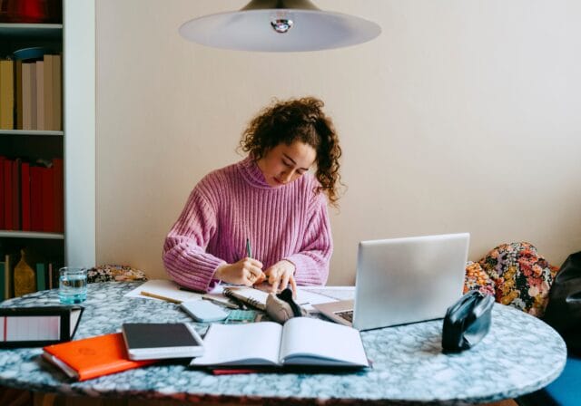 female-student-studying-homework-using-laptop