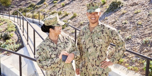 two servicemembers in uniform and smiling