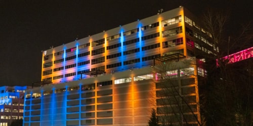 T-Mobile Bellevue headquarters lit up with blue and yellow lighting at night