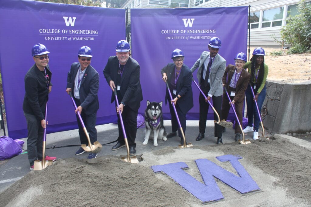 Image of T-Mobile and University of Washington officials at the Interdisciplinary Engineering Building groundbreaking ceremony. The people in the image are T-Mobile’s Kevin Lau, John Saw, Neville Ray, “Dubs” the Husky, UW President Ana Mari Cauce, UW Engineering student Liban Hussein, Dean Nancy Allbritton, of the UW College of Engineering (wearing brown jacket), and UW Engineering student (in green shirt) Aisha Cora 