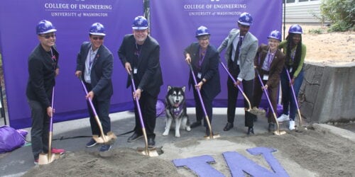 Image of T-Mobile and University of Washington officials at the Interdisciplinary Engineering Building groundbreaking ceremony. The people in the image are T-Mobile’s Kevin Lau, John Saw, Neville Ray, “Dubs” the Husky, UW President Ana Mari Cauce, UW Engineering student Liban Hussein, Dean Nancy Allbritton, of the UW College of Engineering (wearing brown jacket), and UW Engineering student (in green shirt) Aisha Cora