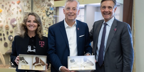 Photo of T-Mobile executives at Smithsonian exhibit.