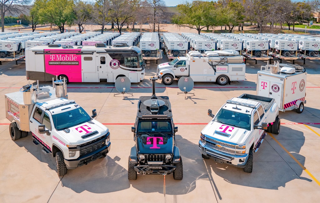 Large fleet of heavy-duty emergency vehicles and portable generators all branded with the T-Mobile logo