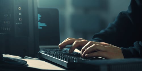 hacker at computer keyboard