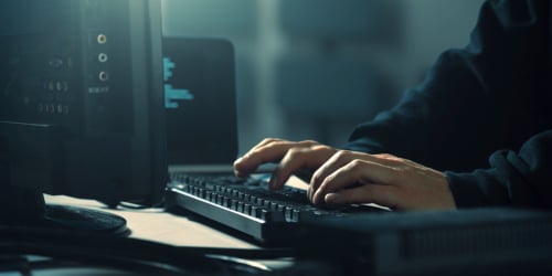 hacker at computer keyboard