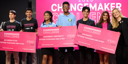 Image of students holding large checks for T-Mobile's Changemaker Challenge