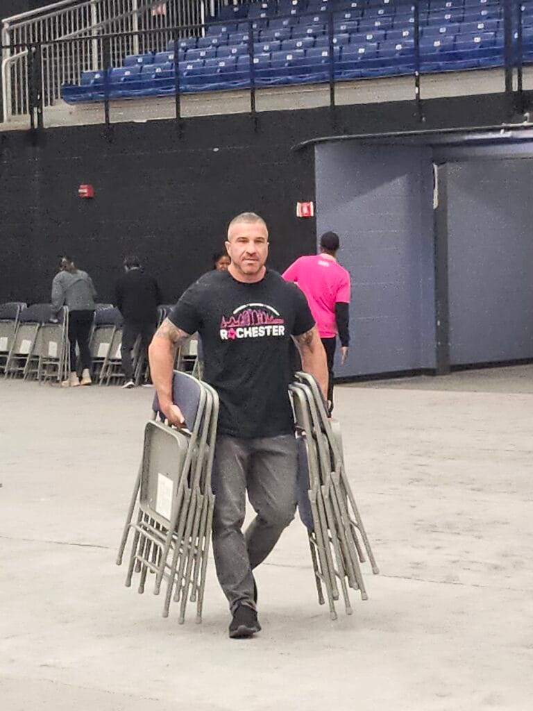 CEC Rochester Director Larry Petrone volunteering to set up Center For Youth's biggest fundraiser event.