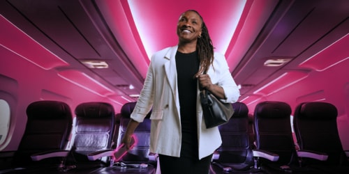Woman walking down the airplane aisle