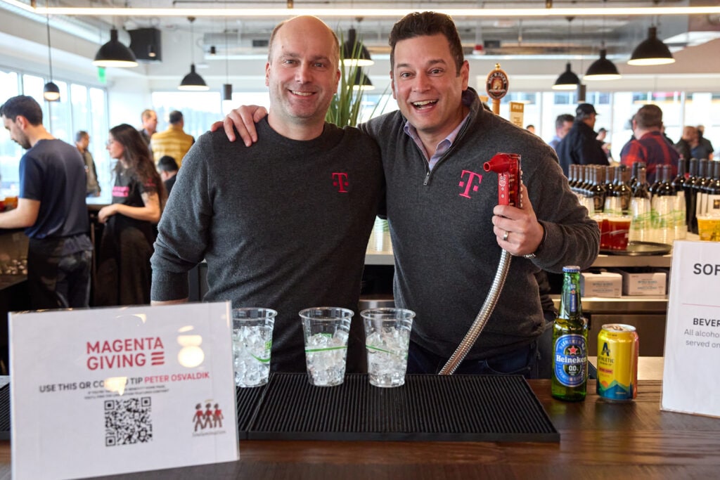Peter Osvaldik, T-Mobile EVP and Chief Financial Officer, and Mike Katz, President, Marketing, Strategy & Products, serves beverages to employees 