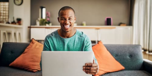 Man sitting on couch with laptop