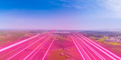 t-mobile network depicted with magenta light beams over a central valley rural community