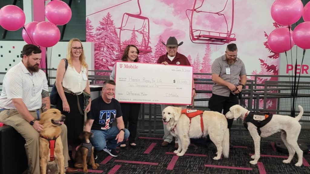 Hero's Puppy for Life founder and ADA-compliant service dogs visit the T-Mobile Customer Experience Center in Colorado Springs to accept their $10,000 donation.