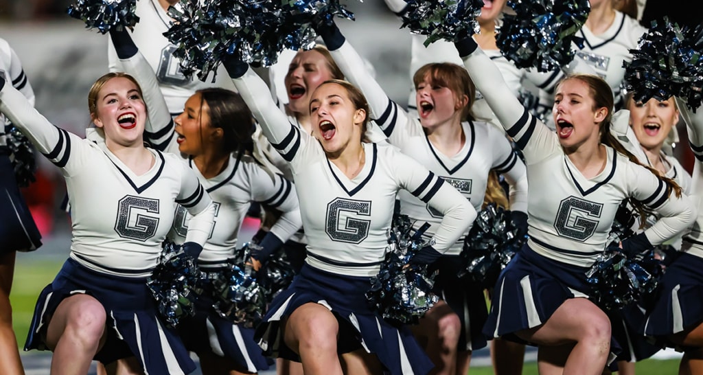Greenwood High School cheerleaders perform at a football game