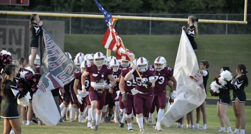 South Caldwell High School football team runs on the field
