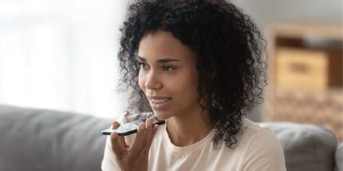 Woman uses virtual assistance AI on smartphone