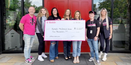 Members of Ronald McDonald House hold check for $10K given to them by T-Mobile