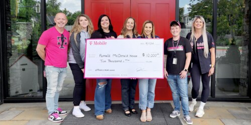 Members of Ronald McDonald House hold check for $10K given to them by T-Mobile