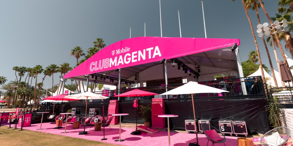 A photo of the Club Magenta lounge area at a festival. 
