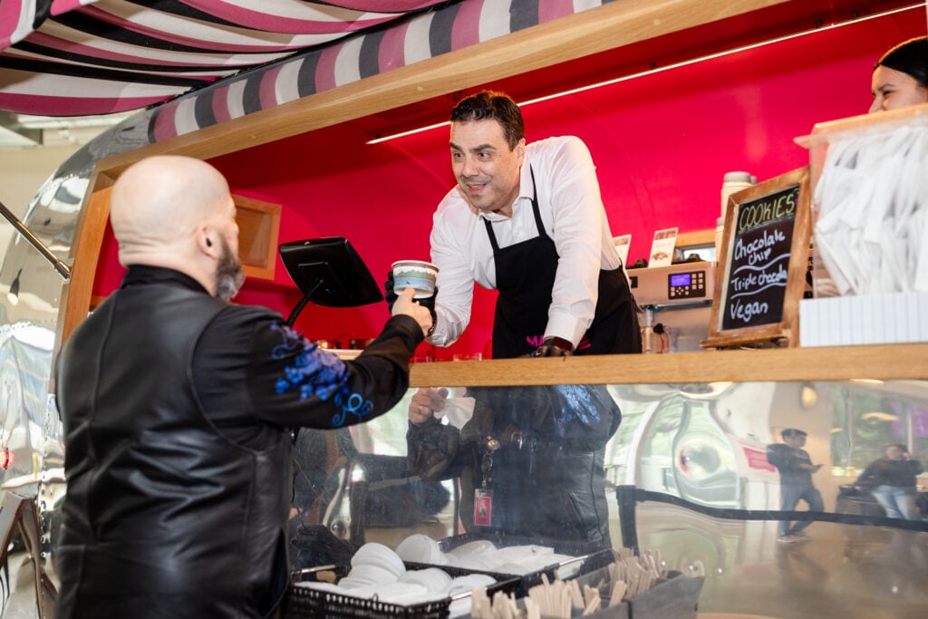 Omar Tazi, EVP, Chief Product Officer at T-Mobile, shares a sweet moment while dishing out treats during the Froyo for Good fundraiser