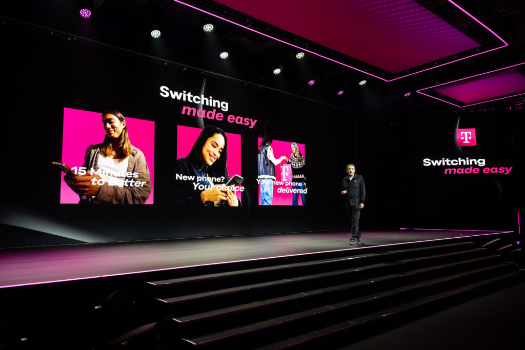 T-Mobile President and CEO, Srini Gopalan, unveils the company's latest news on stage at ARIA Resort and Casino during the Formula 1 Las Vegas Grand Prix on Nov. 20, 2025. T-Mobile announced Switching Made Easy, making switching providers easy, fast and smart, with new AI-powered plan matching, the freedom to get a new phone later, and same-day device delivery via DoorDash. (Brian Friedman/AP Content Services for T-Mobile)