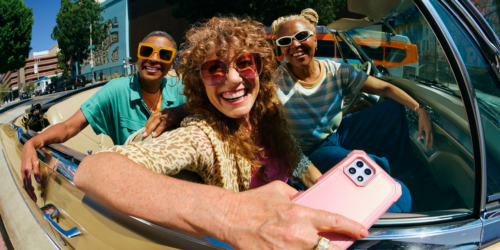 friends in a car smiling