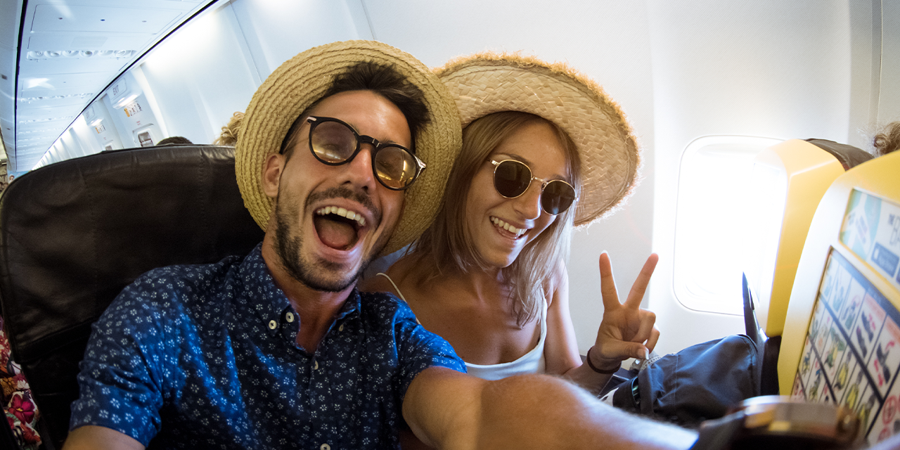 excited couple on a flight