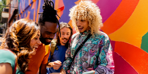 Happy group of friends looking at a phone